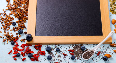 Ingredients for cooking Granola. Food or Healthy diet concept.Breakfast with various cereals and muesli, cereal seeds and nuts on a wooden background.Copy space for Text.selective focus.の写真素材