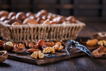 Nuts Mixed on Wooden Background.Assortment, Walnuts,Pecan,Peanuts,Almonds,Hazelnuts,Macadamia,Cashews,Pistachios.Concept of Healthy Eating.Vegetarian.selective focus.の写真素材