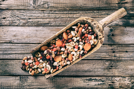 Nuts and dried fruit mix . Concept of Healthy Food. Vintage wooden background. Copy space for Text. Toned image.Vintage style.selective focusの写真素材