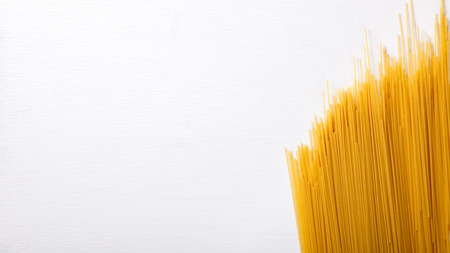 Spagetti Dry Pasta made from durum  on White Background.Copy space for Text. selective focus.の写真素材