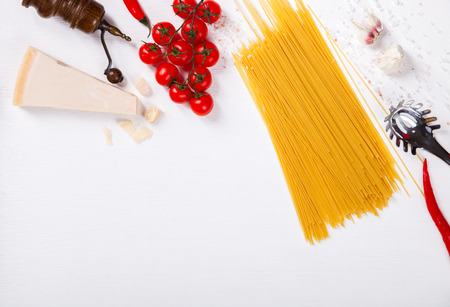 Pasta Spaghetti with ingredients for cooking pasta on a white background, top view. Copy space for Text. selective focus.の写真素材