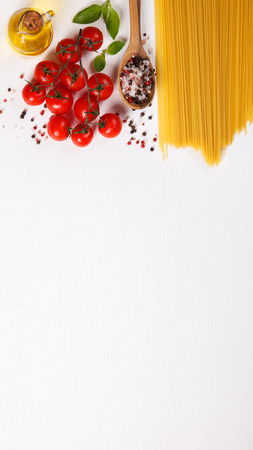 Pasta Spaghetti with ingredients for cooking pasta on a white background, top view. Copy space for Text. selective focus.の写真素材