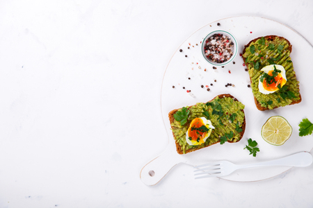 Avocado Vegetable. Sandwiches with Guacamole ,Egg and Parsley on a White Background.Appetizer.Food or Healthy diet concept.Copy space for Text. selective focus.の写真素材