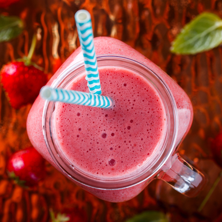 Strawberry Smoothie,Drink in a glass Jar for Drinks on Vintage wooden background.Food or Healthy diet concept.Vegetarian.Copy space for text. selective focusの写真素材
