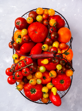 Various Fresh  Tomatoes in the iron basket. Food or Healthy diet concept.の写真素材