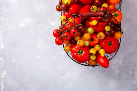 Various Fresh  Tomatoes in the iron basket. Food or Healthy diet concept.の写真素材