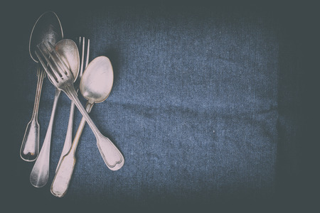 Old Vintage  Silverware Spoons on a dark textile background.Antique.Top View.Copy space for Text.Toned image.Vintage style.selective focus.の写真素材