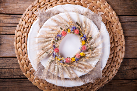 Autumn table setting . Holiday Decorations.Thanksgiving dinner. Wreath  with plate and cutlery.Top View. selective focus.の写真素材