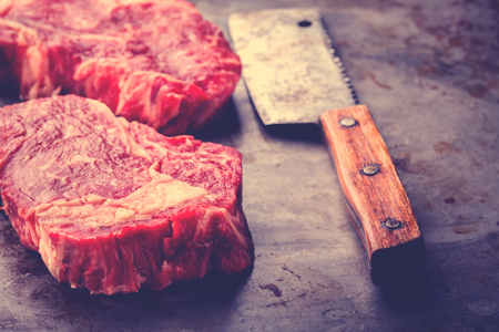 Raw Fresh Marbled Meat Beef Steak. Meat Cleaver  for Cooking Toned image Vintage styleの写真素材