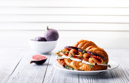 Fresh Croissant Sandwich with  Ham, Cheese, Thyme and figs Breakfast Delicious Baking  Refreshment Copy space for Textの写真素材