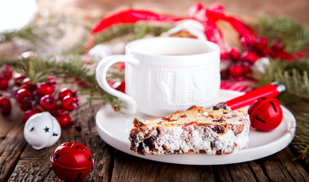 Dresdnen Stollen is a Traditional German Cake with raisins on a light knitted background.Gift for Christmas.Vintage style.Fruit cake for the Holiday. German, European festive dessert.の写真素材