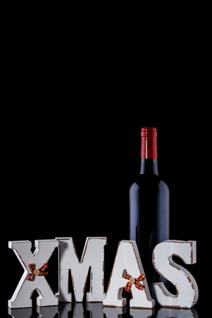 Christmas  Bottle of Red Wine for a Festive Fragrant Traditional Drink Mulled wine Alcohol on the Black Background Decorationの写真素材
