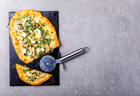 Pizza Mozzarella Mushrooms Arugula with a Pesto Sauce Food on a Gray Stone Background baking Top...
