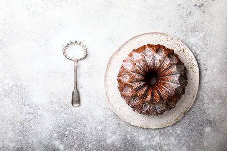 Cake sprinkled with Sugar Powder on the Gray Concrete Background. Sweet Dessert. Biscuit Biscuit Cake Top View Copy space for Text の写真素材