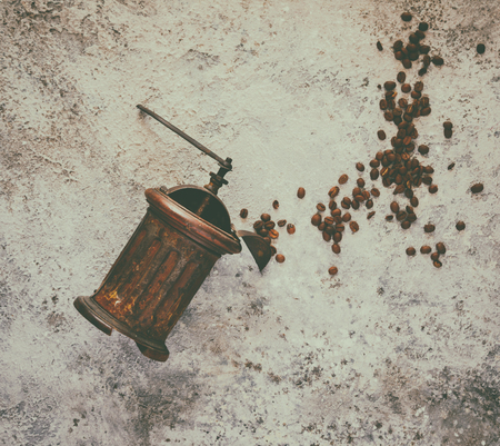 Coffee grinder Hand Vintage with roasted coffee beans  on a gray background. Top View.Copy space for Text.Toned image Vintage Style.の写真素材