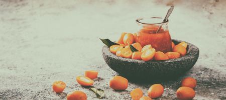 Kumquat Jam on the gray background. Bright Citrus.Copy space for Text. Toned image Vintage Style.の写真素材