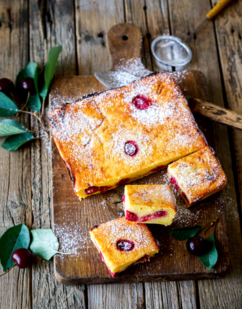 Cheesecake Russian Traditional Cottage cheese casserole with cherry. Summer Berry Season. Wooden background.selective focus.Vintage Styleの写真素材