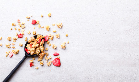 Granola Cereal bar with Strawberries in a spoonful Background .Breakfast. Healthy Food sweet dessert snack. Diet Nutrition Concept.Vegetarian food. Flat Lay.Top View. Copy spaceの写真素材