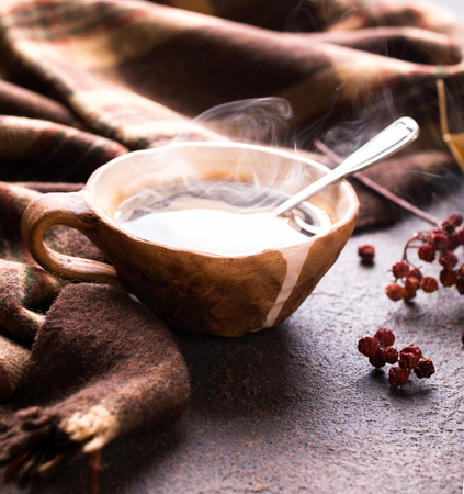 Hot evaporating cup of coffee .Autumn, relaxing, teatime and still life concept. Selective focus.の写真素材