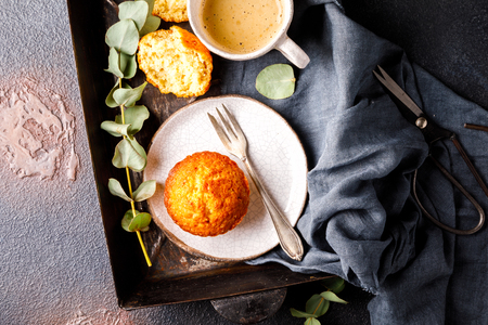Muffin snack and a cup of coffee on the background baking tray.Copy space for Text.の写真素材