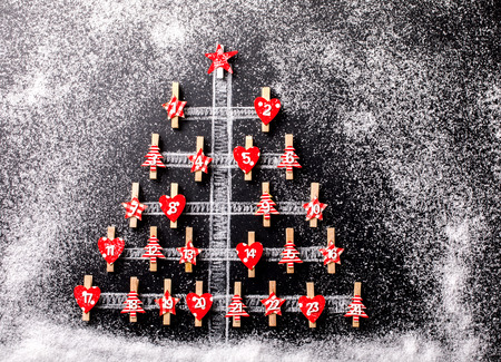 Christmas tree on a holiday black background. Minimal New year Concept.  Advent Calendar.Flat lay. Top View Copy space for Text. Drawn Snowfall.の写真素材