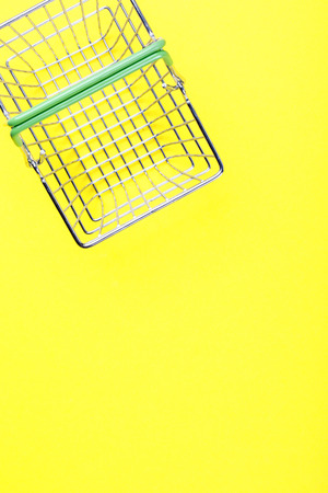 Shopping basket is empty on a bright yellow background. Conception Festive Sale Discount. Trading Supermarket Retail.Copy space .Top View. Flat Lay.の写真素材