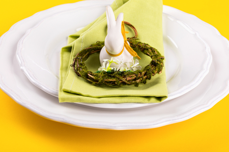 Easter table setting  on a bright yellow background. Holiday decoration.Happy Easter concept.の写真素材