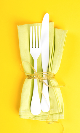 Easter table setting with  Kitchen cutlery on a bright yellow background. Holiday decoration.Happy Easter concept. Top View. Flat Lay.の写真素材