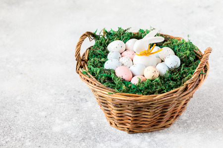 Easter concept.bunny in a basket with easter colored eggs.Copy space for Text.
の写真素材