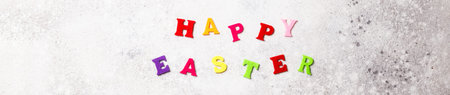 Easter holiday concept on a gray background. Inscription in colored letters.Spring mood.Banner.の写真素材