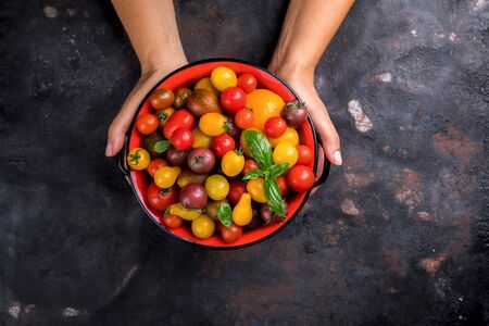 Cherry tomatoes. Summer useful vegetable for vegetarians. Variety of colors and tastes.の写真素材