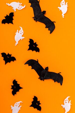 Halloween postcard. Ð¢raditional festival of autumn. Decoration and party concept. Bats and ghosts on orange background. Flat lay, top view, copy spaceの写真素材