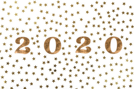 Happy New Year 2020 . Festive Shining starry composition on isolated white background with wooden...