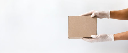 Concept of safe package delivery against Coronavirus 2019-nCov in a pandemic. Mail courier in...