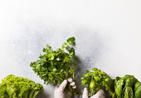 Concept of safe shopping at grocery stores during a pandemic. Fresh greens, salad vitamins for to enhance immunity. Personal protective equipment protection against Coronavirus 2019-nCovの写真素材