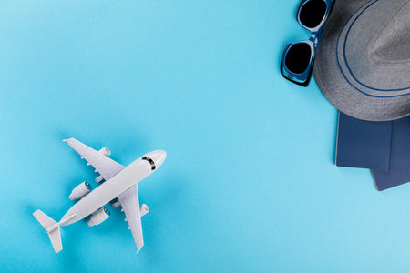  Yellow suitcase with traveler accessories on a blue background.Travel concept. Summer Time...