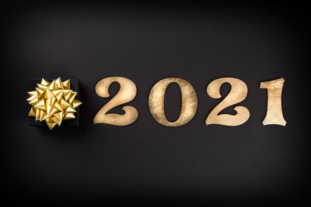 Idea Happy New Year 2021.Beautiful holiday card on a black background.Party invitation.Wooden...