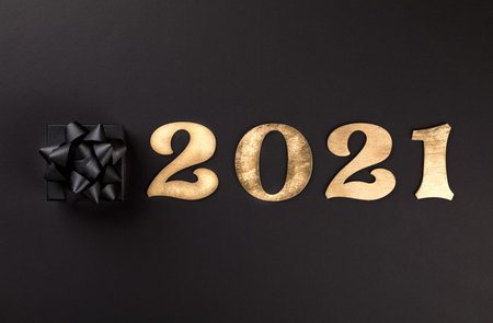 Idea Happy New Year 2021.Beautiful holiday card on a black background.Party invitation.Wooden...