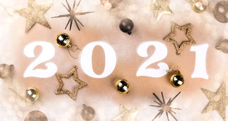 New Year Flat Lay composition Shining Holiday card with Holiday card with numbers 2021 Celebration on a gold background. Holiday party decoration.Flat lay, top view, copy space.の写真素材