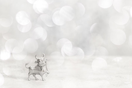 Greeting card Happy New Year metal bull. Christmas traditional holiday.Copy space.Light Effect Bokeの写真素材