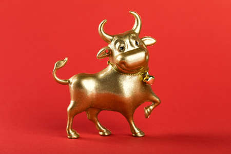 Metallic Gold Bull Red Background Symbol New Years.Holiday postcard.Copy spaceの写真素材