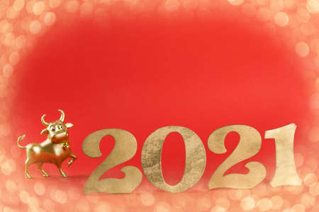 Light Effect BokeMetallic Gold Bull Red Background Symbol 2021 New Year.Holiday postcard.Copy space.の写真素材
