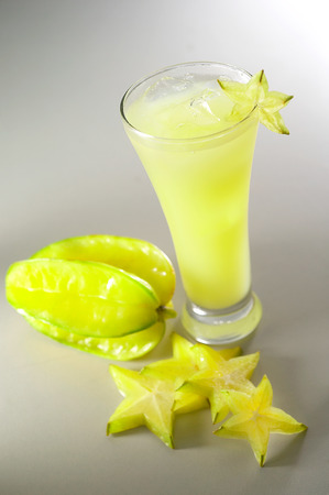 star fruit juice surrounded by carambolasの写真素材