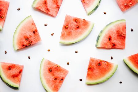 Watermelon pattern. Sliced watermelon and seeds on white background, top viewの写真素材