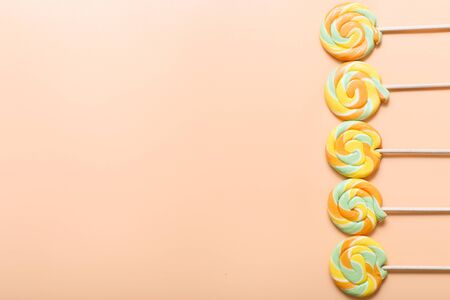 colorful lollipops in row on color background, top viewの写真素材