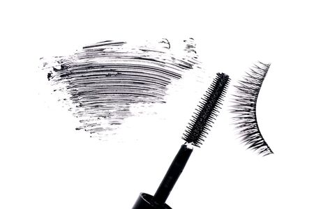 Mascara brush with mascara stroke and fake false eyelash on white backgroundの写真素材