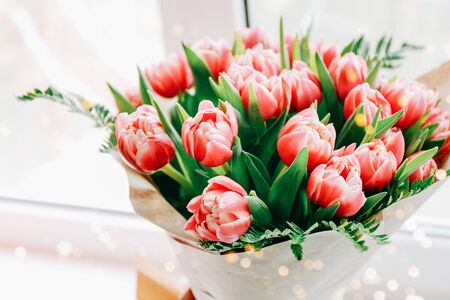 Beautiful bouquet of pink tulips on windowsill background. Gift on Mother dayの写真素材