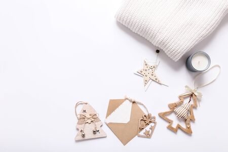 Flat lay with white sweater and Christmas tree toys on white backgroundの写真素材