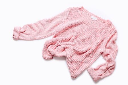 Pink knitted sweater isolated on whiteの写真素材