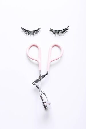 Fashion fake false eyelash with curler on white backgroundの写真素材